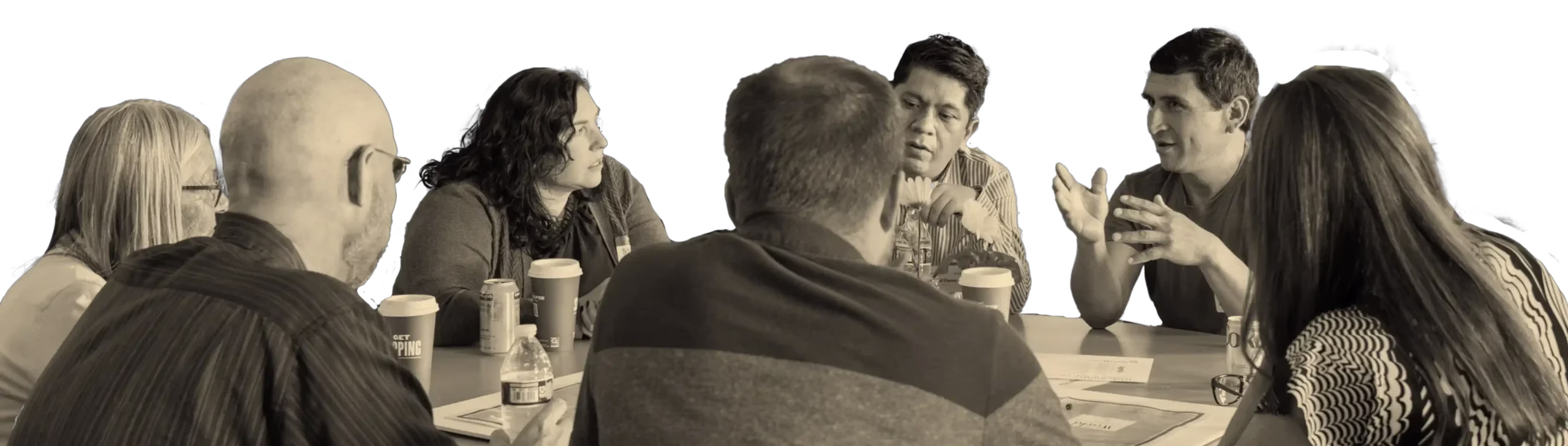 people gathered around a table drinking coffee and telling stories